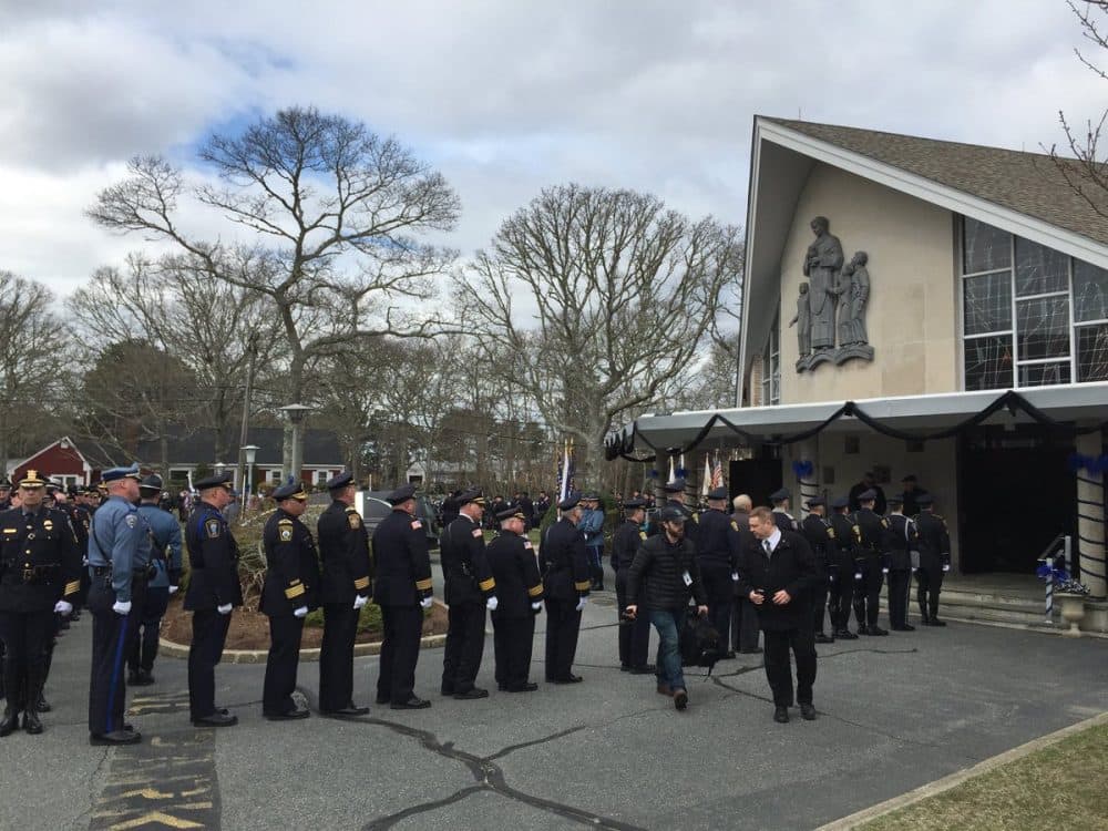 Thousands of officers and civilians file into St. Pius X Parish, a Catholic church, in Yarmouth. (Fred Thys/WBUR)