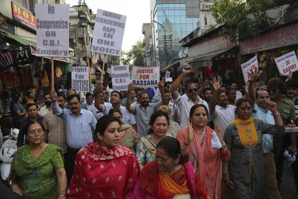 Indians carry placards and march in a rally demanding the investigation into the rape and murder of an 8-year-old girl be handed over to the Central Bureau of Investigation (CBI), in Jammu, India, Thursday, April 19, 2018. (Channi Anand/AP)