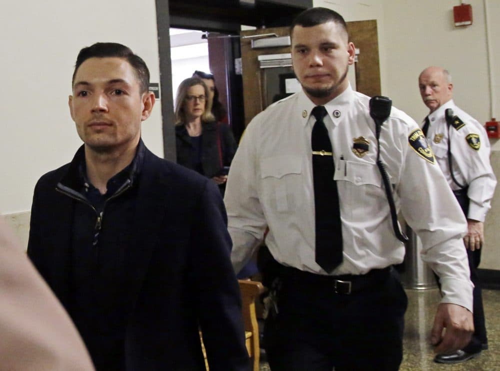 Bryon Hefner, the estranged husband of former Massachusetts Senate President Stan Rosenberg, is escorted out of court after his arraignment at Suffolk Superior Court on Tuesday in Boston. (Elise Amendola/AP)