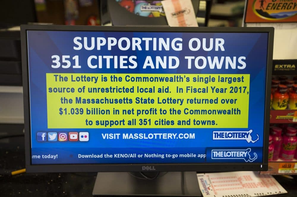 A small TV screen runs Massachusetts State Lottery advertisements on a loop inside a convenience store in Boston. (Jesse Costa/WBUR)