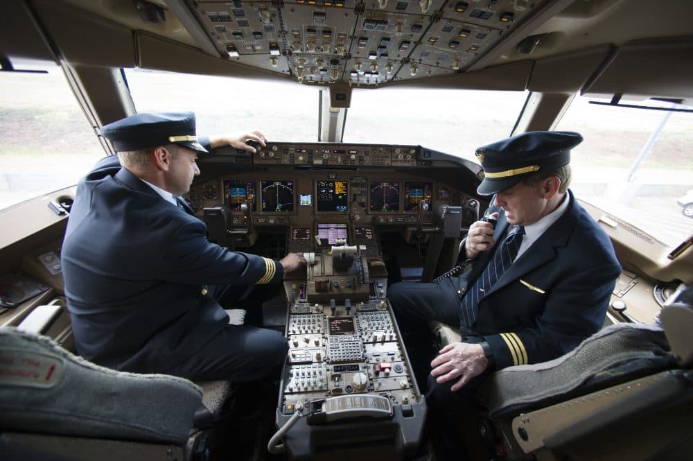 United Airlines Capt. Tommy Holloman, left, and Capt. Chuck Stewart in the cockpit of a United Airlines Boeing 777 at Dulles International Airport Air Traffic Control Tower in Sterling, Va., Tuesday, Sept. 27, 2016. (Cliff Owen/AP)