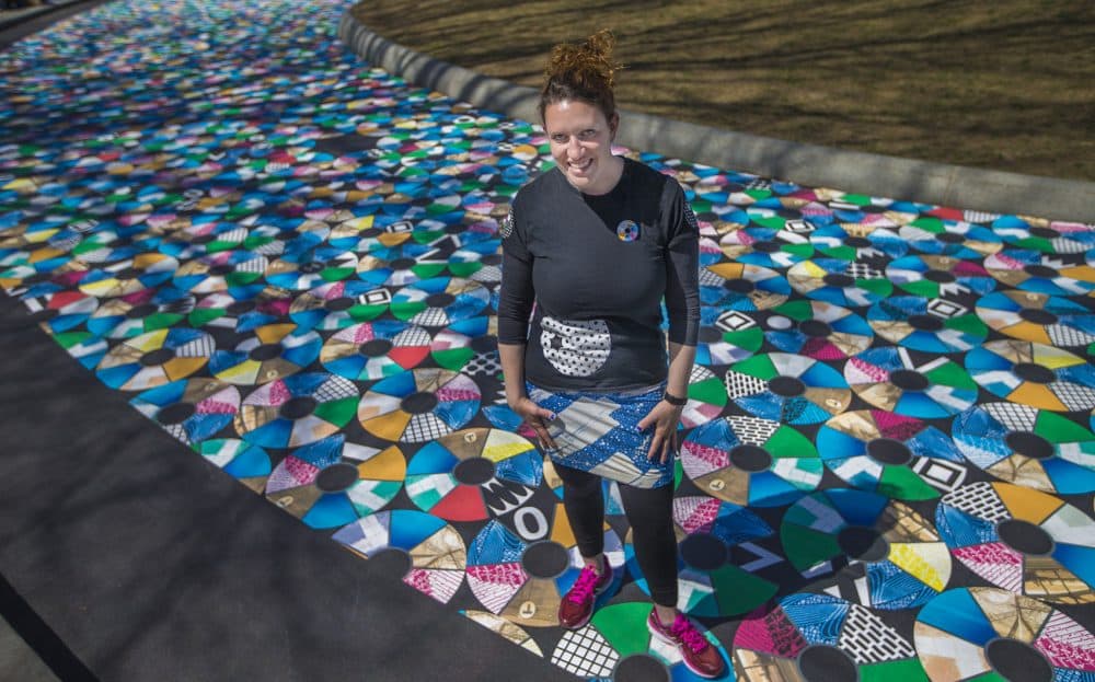 Artist Julie Vogl standing on her art installation on the Common. (Jesse Costa/WBUR)