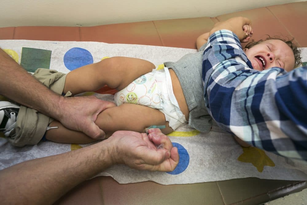 In this Jan. 29, 2015, file photo, pediatrician Dr. Charles Goodman vaccinates 1-year-old Cameron Fierro with the measles-mumps-rubella vaccine, or MMR vaccine at his practice in Northridge, Calif. (Damian Dovarganes/AP)