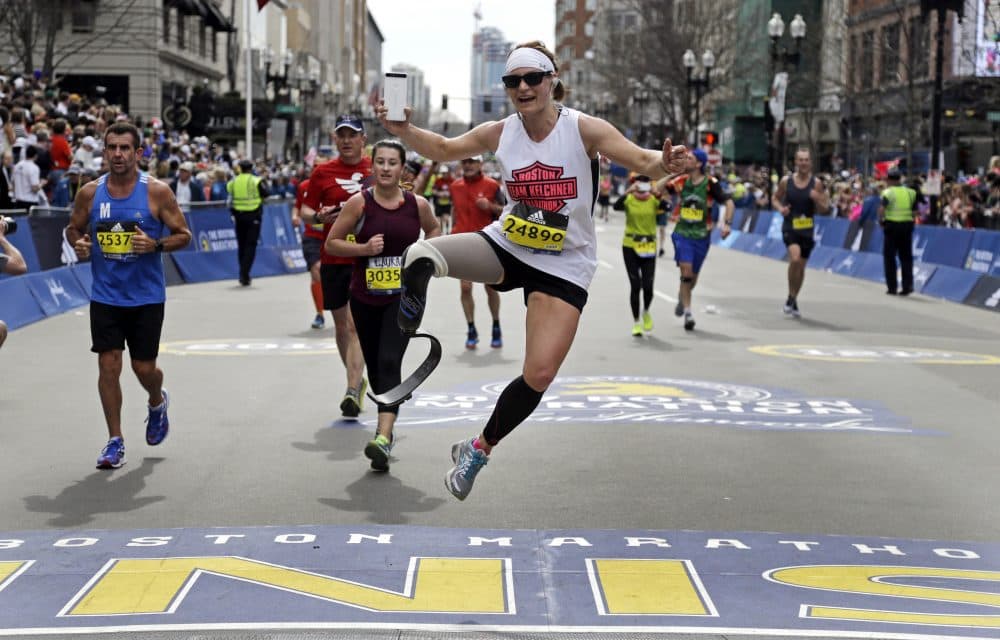 Jennifer K. Stedman, of Auburn, Calif., jumps as she finishes the 121st Boston Marathon on Monday, April 17, 2017. (Elise Amendola/AP)