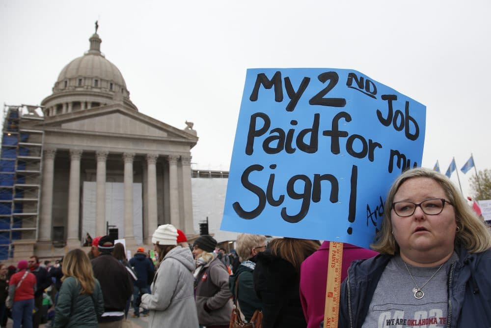 Melissa Knight, who teaches art at Ardmore, Okla. middle school, holds a sign as teachers rally at the state Capitol in Oklahoma City, Monday, April 2, 2018 to protest low school funding. (Sue Ogrocki/AP)