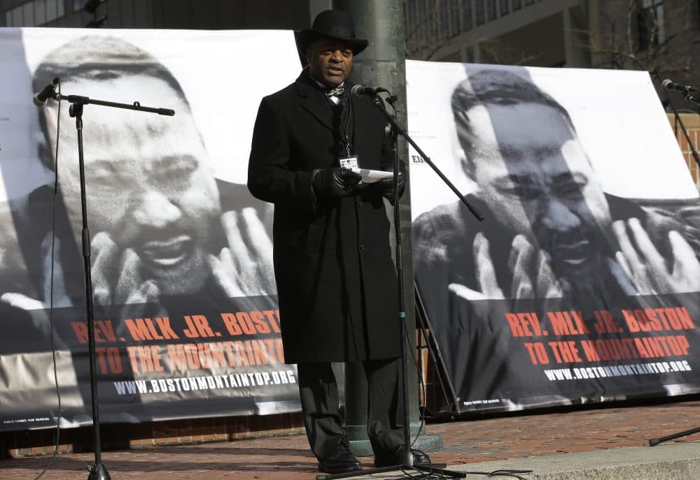 Nation of Islam Minister Rodney Muhammad reads a short passage from Martin Luther King Jr.'s last speech before King's assassination 50 years ago this week during a remembrance Monday on City Hall Plaza in Boston. (AP Photo/Steven Senne)