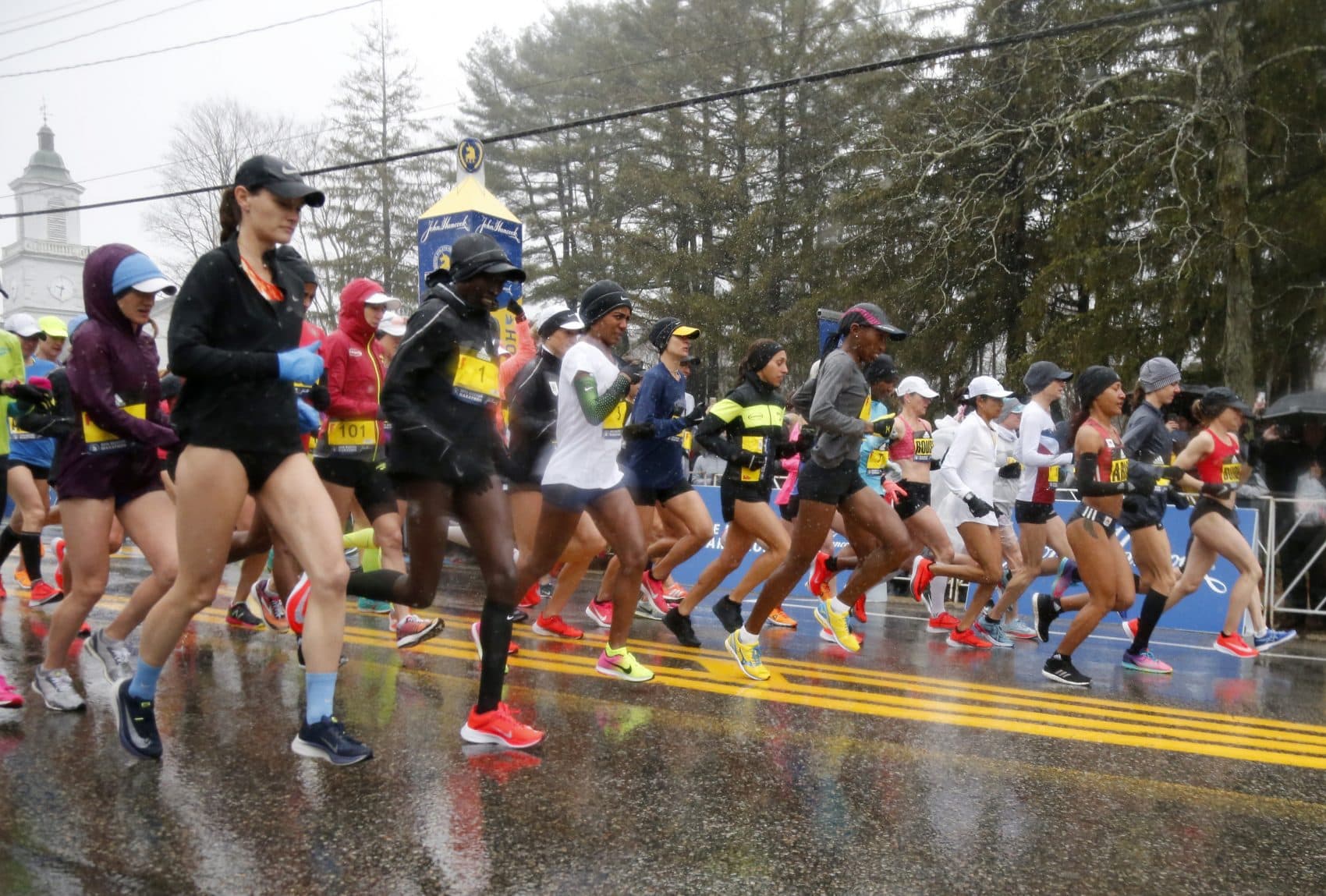 The elite female runners break from the starting line in a downpour during the 122nd running of the Boston Marathon. (Mary Schwalm/AP)