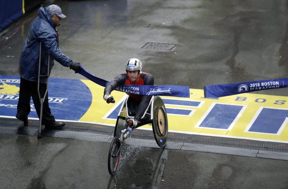 Marcel Hug, of Switzerland, crosses the finish line to win the men's wheelchair division. (Charles Krupa/AP)