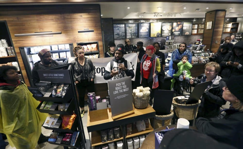 Demonstrators occupy the Starbucks that has become the center of protests Monday, April 16, 2018, in Philadelphia. Starbucks wants to add training for store managers on &quot;unconscious bias,&quot; CEO Kevin Johnson said Monday, as activists held more protests at a Philadelphia store where two black men were arrested after employees said they were trespassing. (Jacqueline Larma/AP)