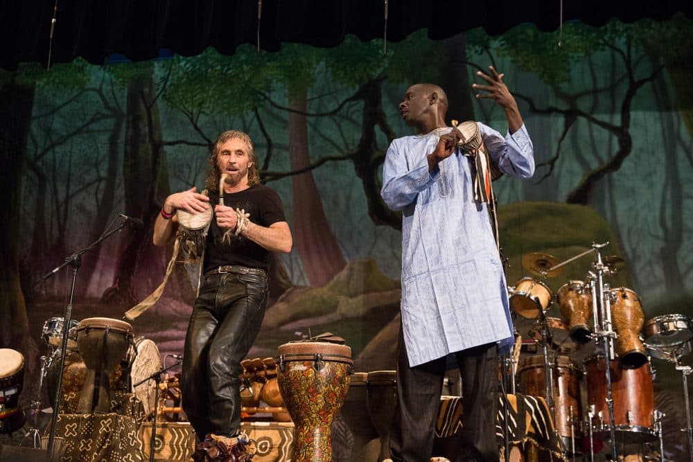 Massamba Diop (right) and Tony Vacca (left) perform during an assembly at Roger Ludlowe Middle School in Fairfield, Connecticut. (Ryan Caron King/Connecticut Public Radio)