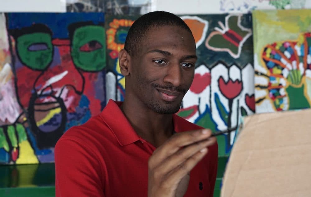 Naieer, one of the young adults profiled in the documentary, paints at the Henderson Inclusion School in Boston. (Courtesy)