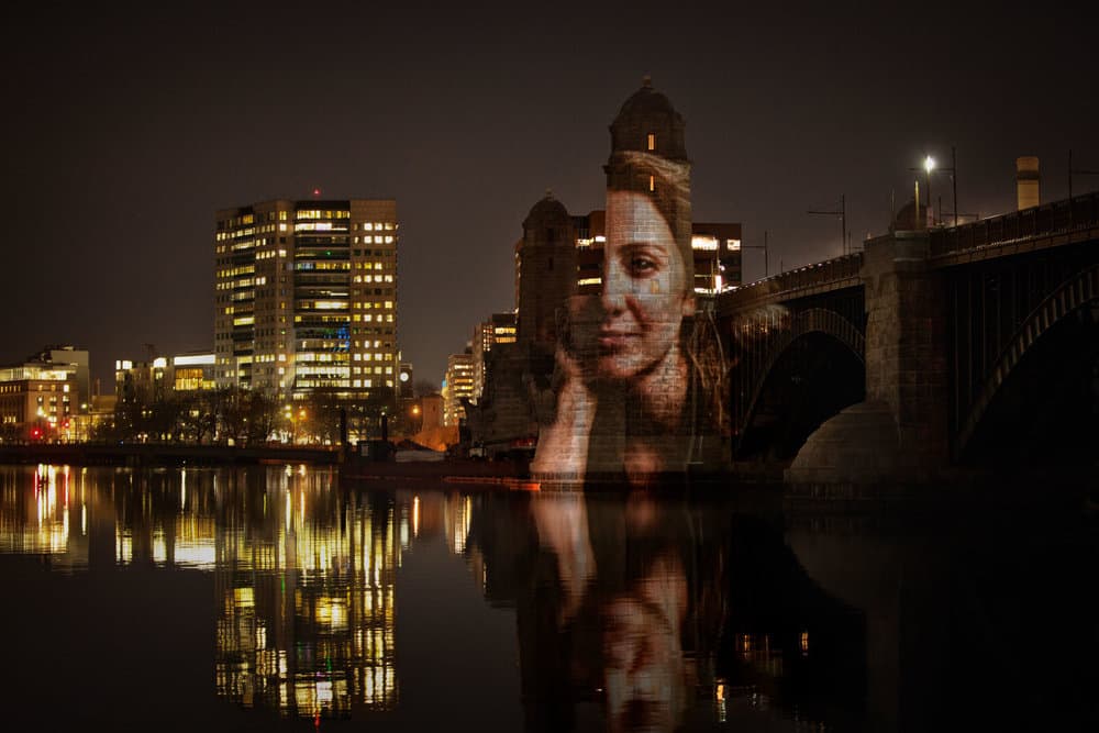 A portrait of computational biologist Pardis Sabeti projected on the Longfellow Bridge. (Courtesy Erik Jacobs)