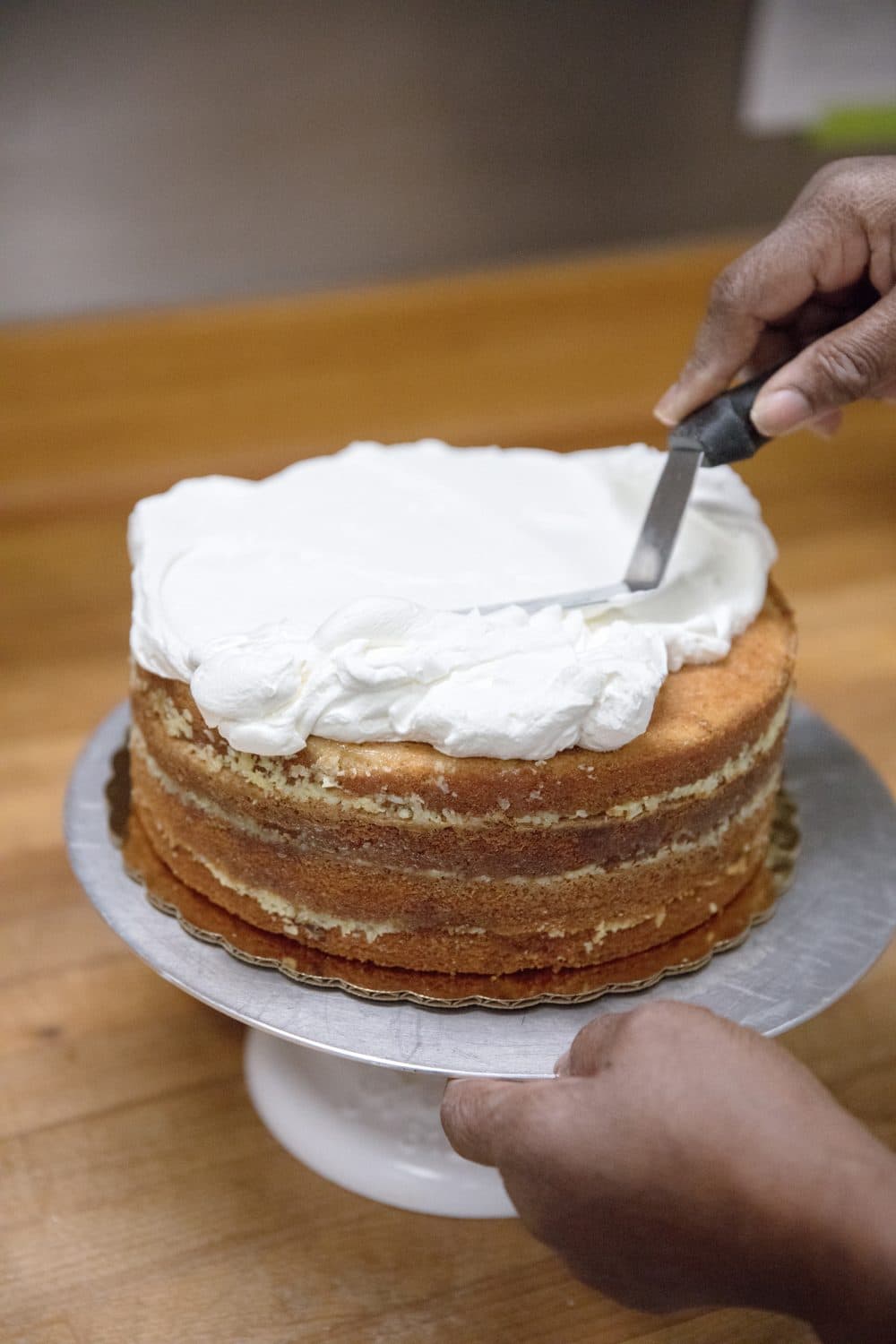 Dolester Miles puts the icing on her coconut pecan cake. (Courtesy Carry Norton)