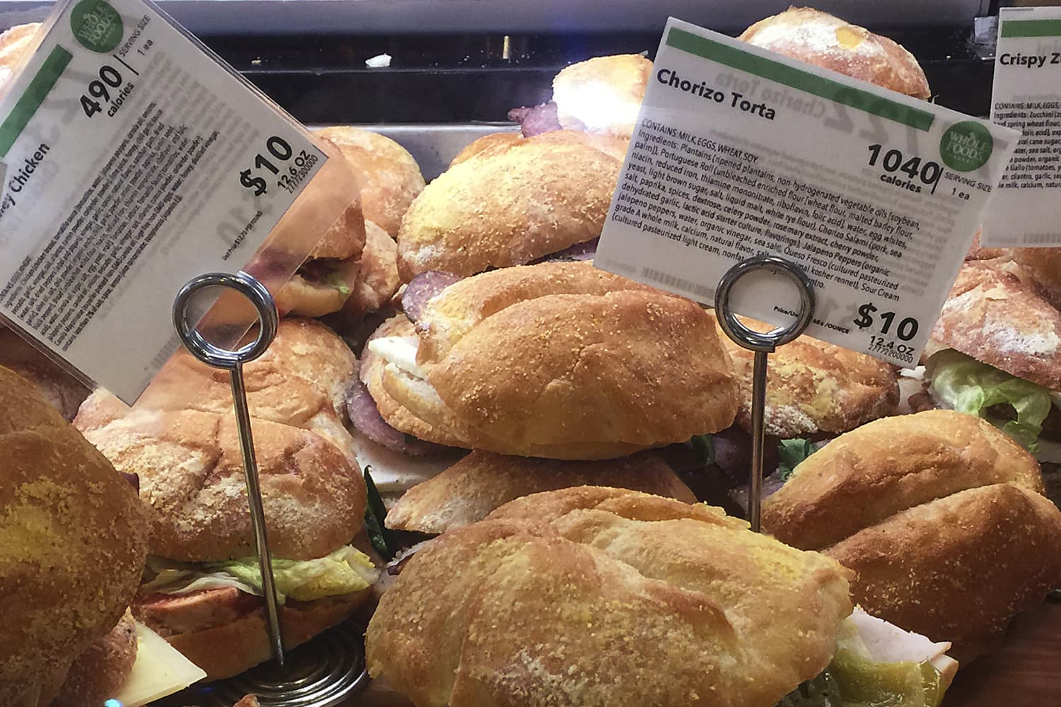 In this May 3, 2017 file photo, information cards provide calorie count and price for food items on display at a Whole Foods store, in New York. (Candice Choi/AP)