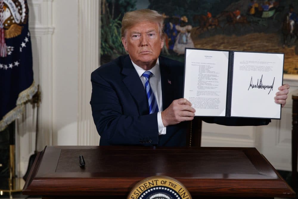 President Trump shows a signed Presidential Memorandum after delivering a statement on the Iran nuclear deal from the White House, Tuesday in Washington. (Evan Vucci/AP)