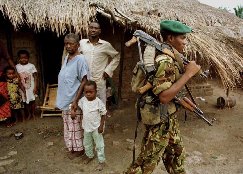 A Congolese rebel walks through the village of Kabalo, in eastern Congo, in November 1998. (Brennan Linsley/AP)