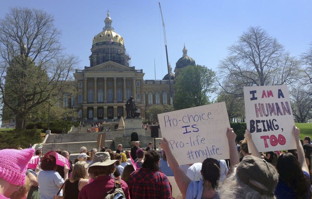 Planned Parenthood supporters rally outside the Iowa Capitol Building, Friday, May 4, 2018, in Des Moines, Iowa. The rally called for Iowa Gov. Kim Reynolds to veto a six-week abortion ban bill that would give the state the strictest abortion restrictions in the nation. (Barbara Rodriguez/AP)