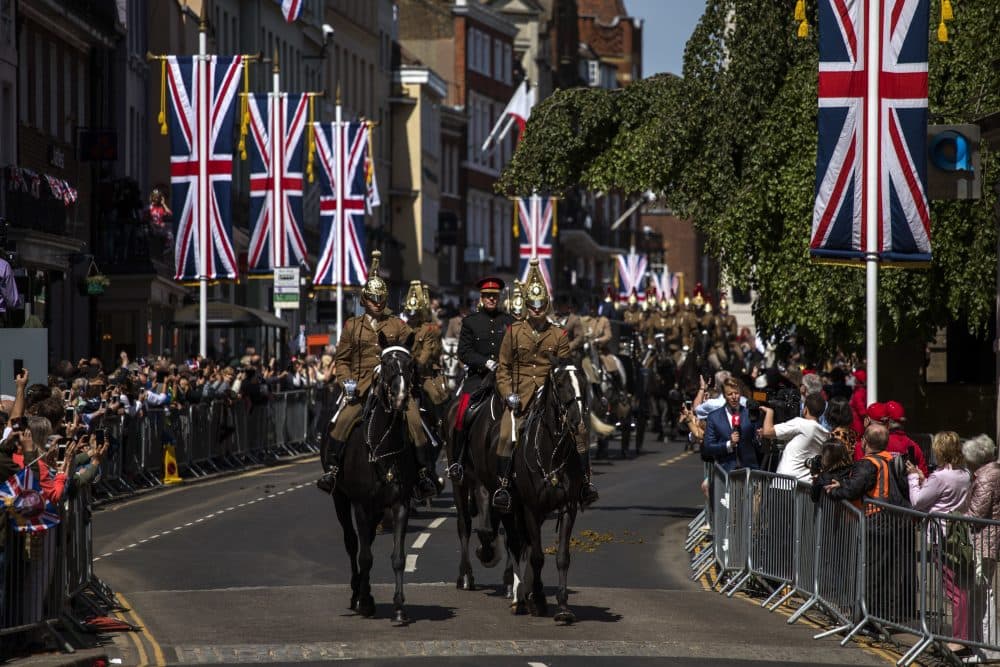Members of the armed forces ride horses during a parade rehearsal, ahead of Prince Harry and Meghan Markle's wedding in Windsor, England, Thursday, May 17, 2018. Preparations continue in Windsor ahead of the royal wedding of Britain's Prince Harry and Meghan Markle Saturday May 19. (AP Photo/Emilio Morenatti)
