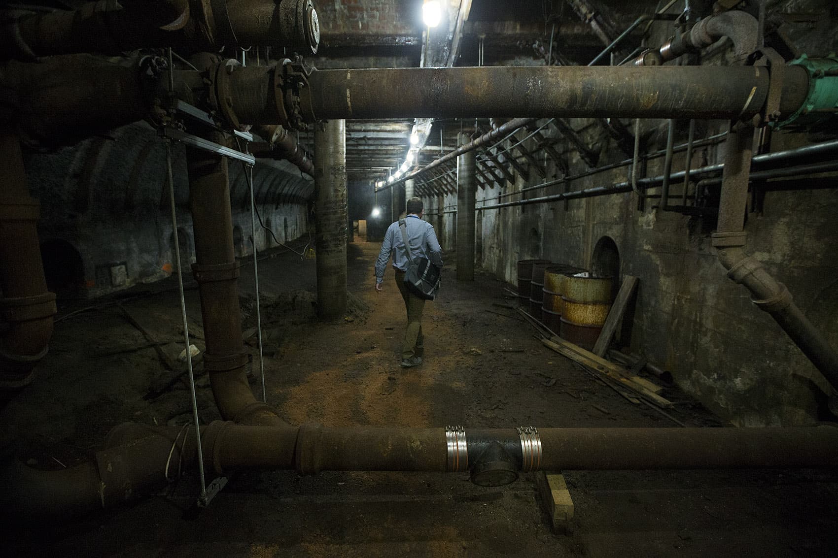 City of Boston archaeologist Joe Bagley walks through the first of two sections of an old MBTA tunnel, which traveled between Scollay Square and Adams Square, and is believed to have been shut down in 1963. (Jesse Costa/WBUR)