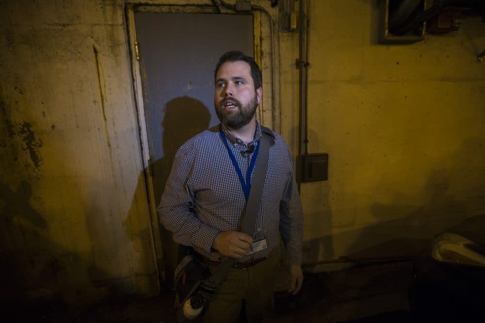 City archaeologist Joe Bagley stands before a door in the City Hall garage, the gateway to the old MBTA tunnel. (Jesse Costa/WBUR)