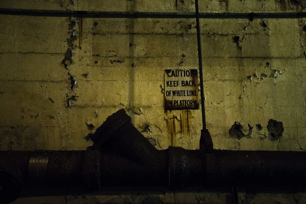 Some signage from the old Adams Square station still hangs on the wall. (Jesse Costa/WBUR)