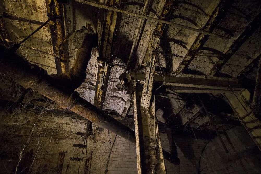 The original supports and an old light fixture on the ceiling of the tunnel (Jesse Costa/WBUR)