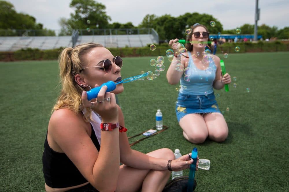 Lexx Talbot and Bridget Bell relax on the grounds of Harvard Athletic Complex. (Jesse Costa/WBUR)