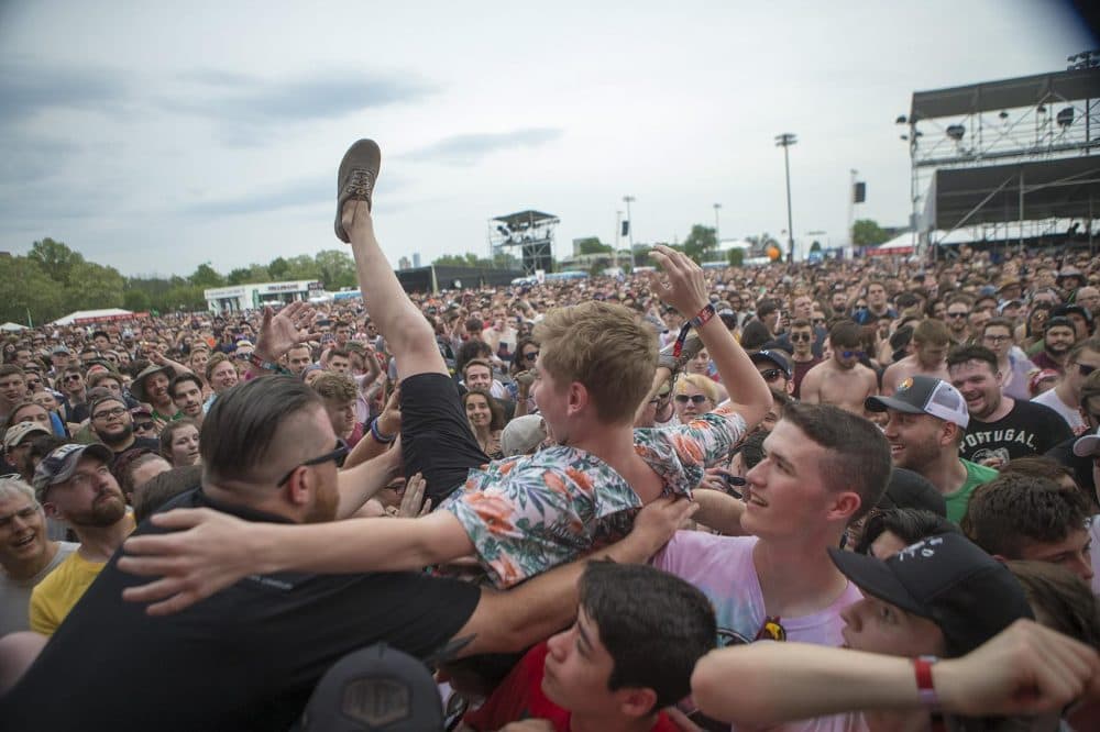 Security removes a crowd surfer from the audience. (Jesse Costa/WBUR)