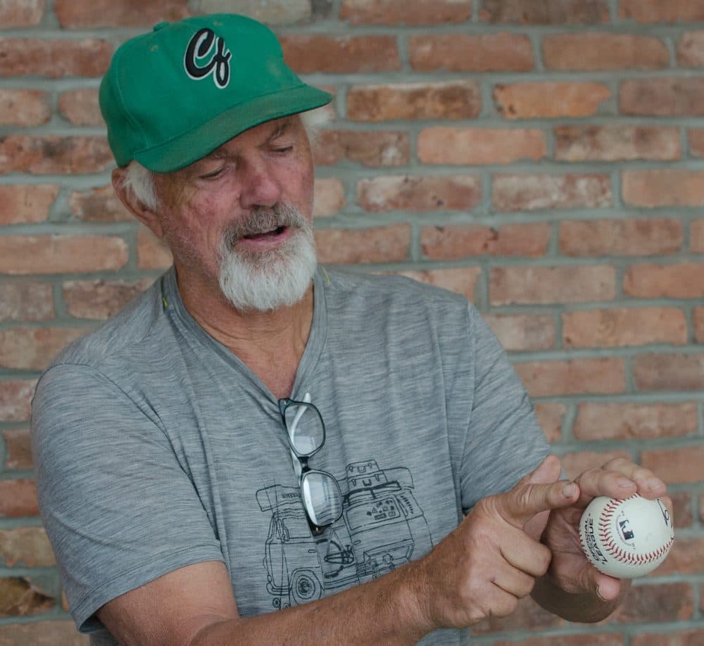 Bill Lee points out the details of his fastball grip. (Sharon Brody/WBUR)