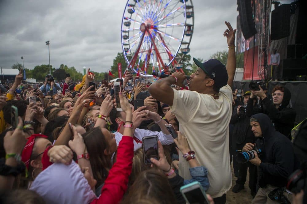 Boston-based rapper Cousin Stizz greets the crowd during his performance at Boston Calling. (Jesse Costa/WBUR)