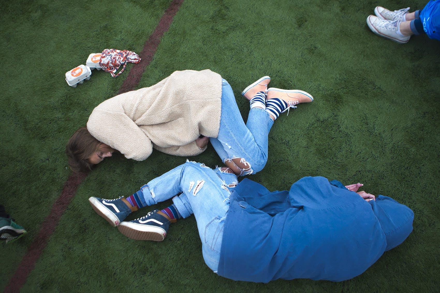 Despite the rain, festival-goers still took a minute to rest on the AstroTurf. (Jesse Costa/WBUR)