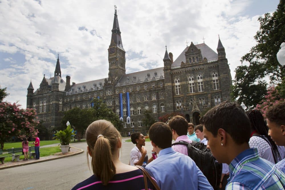 In this July 10, 2013, file photo, prospective students tour Georgetown University's campus in Washington. (Jacquelyn Martin/AP)