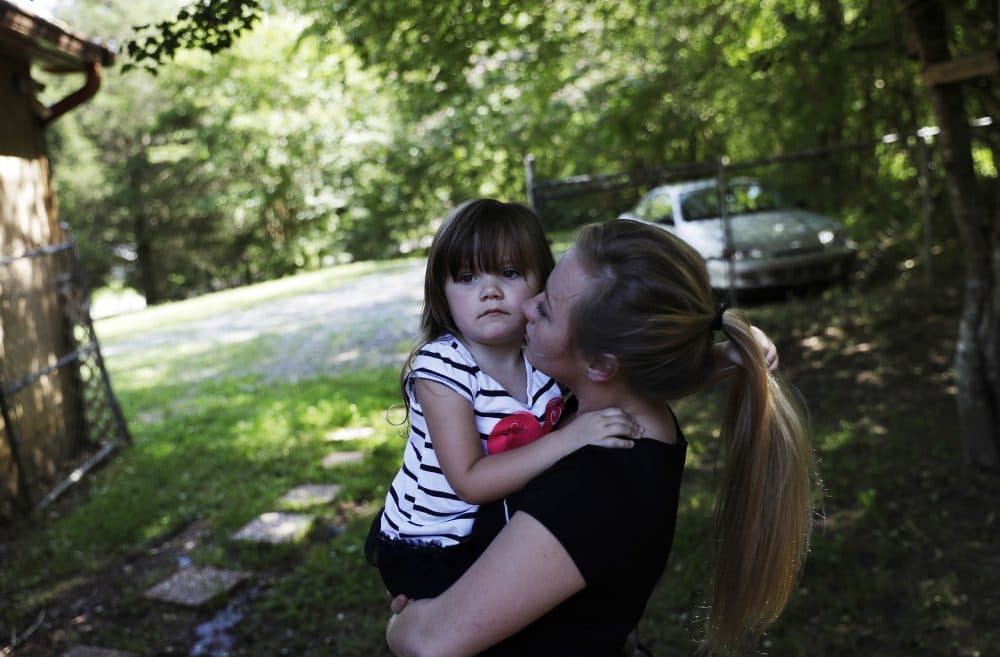 Whitney Duncan holds her daughter, Deklyn, 3, while visiting her at the home she's staying at with her grandmother in Jasper, Ga., Monday, June 26, 2017. Duncan and her husband were given a choice after failing a drug screening in 2016; lose their daughter to foster care or temporarily give her to a family member while they enter the county's two-year family drug court program to help with their opioid addiction. (David Goldman/AP)
