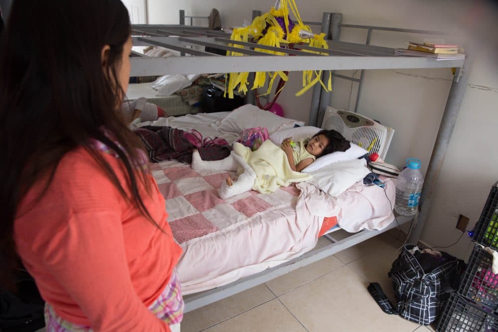 In this Dec. 15, 2015, photo, Marleny Gonzalez, left, looks at her 4-year-old daughter, Jenifer at a shelter in Reynosa, Mexico, where they are living after trying to cross into the U.S. Gonzalez said her daughter suffered two broken legs when a truck they were traveling in overturned on the journey from Guatemala. (Seth Robbins/AP)