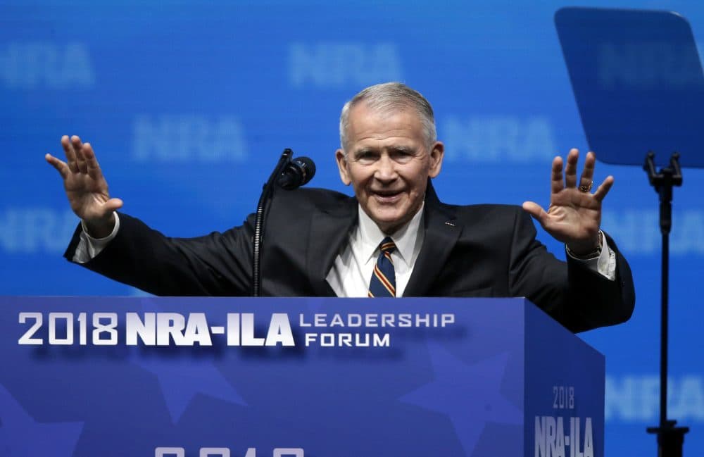 Former U.S. Marine Lt. Col. Oliver North acknowledges attendees as he gives the Invocation at the National Rifle Association-Institute for Legislative Action Leadership Forum in Dallas, Friday, May 4, 2018. (Sue Ogrocki/AP)
