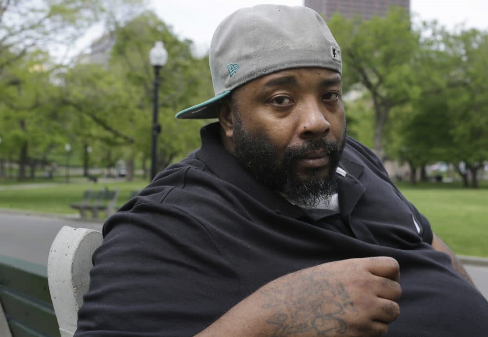 Emory Ellis sits for a photo in a park in Boston. Ellis was arrested in 2015 after he tried to buy breakfast at Burger King using a $10 bill that the cashier thought was fake. (Steven Senne/AP)