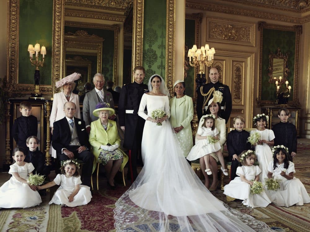 In this photo released by Kensington Palace on Monday May 21, 2018, shows an official wedding photo of Britain's Prince Harry and Meghan Markle, center, in Windsor Castle, Windsor, England, Saturday May 19, 2018. Others in photo from left, back row, Jasper Dyer, Camilla, Duchess of Cornwall, Prince Charles, Doria Ragland, Prince William; center row, Brian Mulroney, Prince Philip, Queen Elizabeth II, Kate, Duchess of Cambridge, Princess Charlotte, Prince George, Rylan Litt, John Mulroney; front row, Ivy Mulroney, Florence van Cutsem, Zalie Warren, Remi Litt. (Alexi Lubomirski/AP)