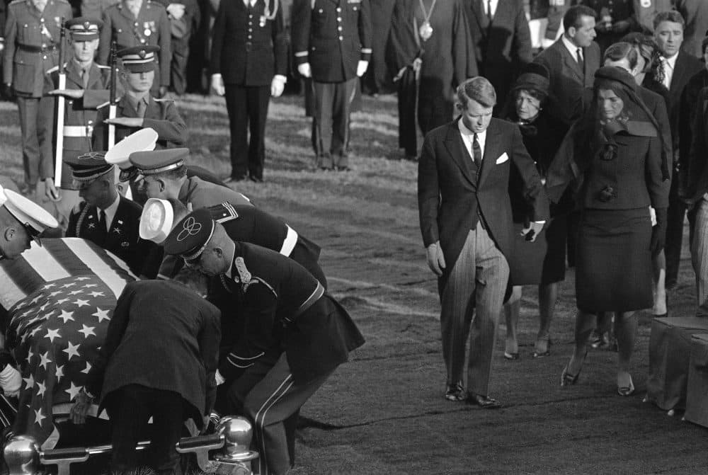 Burial of President John F. Kennedy at Arlington National Cemetery, Nov. 25, 1963. His brother Robert F. Kennedy and widow Jacqueline Kennedy arrive with the president's mother, Rose Kennedy behind them as the coffin is placed at the grave. (John Rooney/AP)
