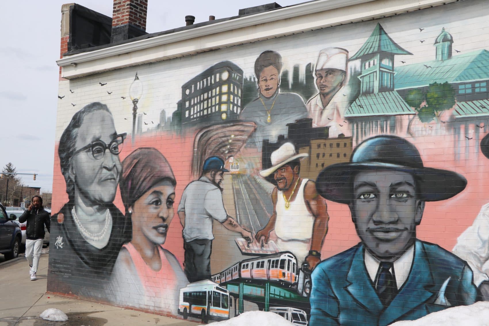 A depiction of Melnea Cass, far left, and other neighborhood icons, in the "Faces of Dudley" mural on Washington Street. (Rachel Paiste/WBUR)