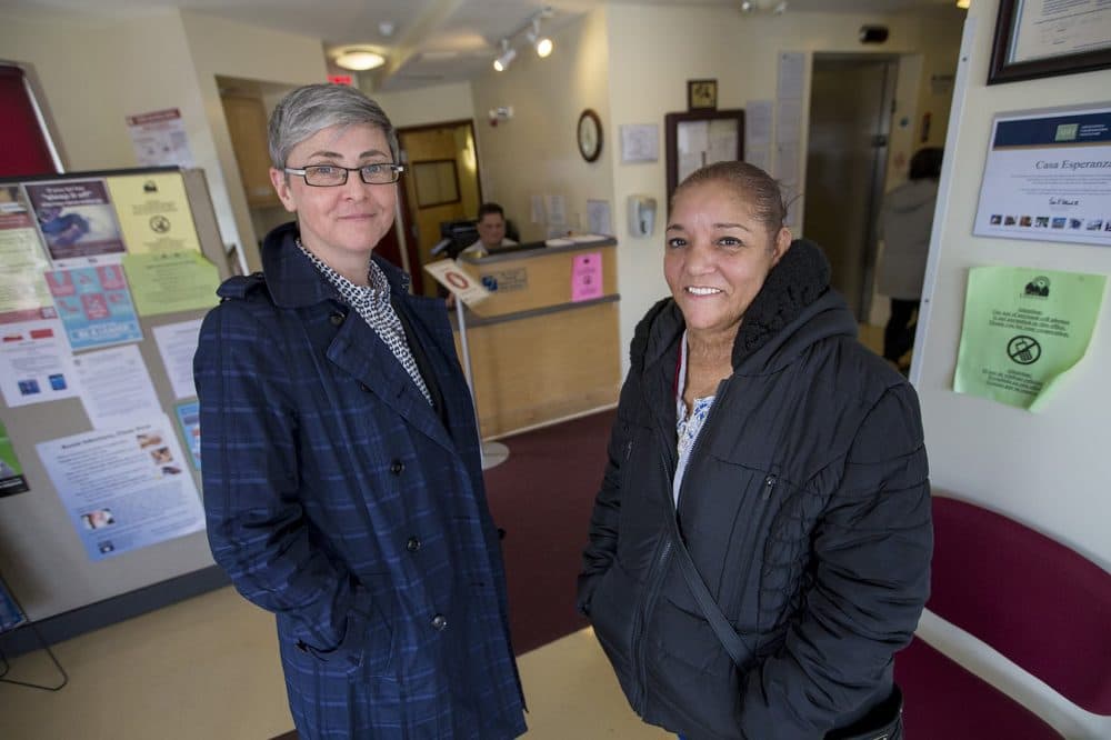 Executive Director Emily Stewart, left, and Director of Programs Anna Rodriguez stand in the lobby of the Casa Esperanza Familias Unidas Outpatient Services. (Jesse Costa/WBUR)