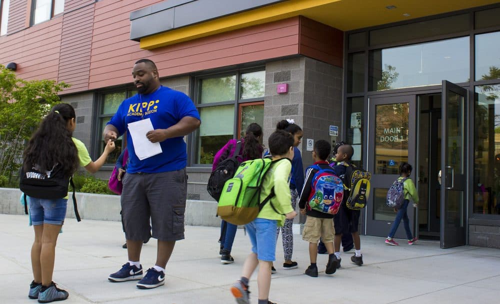 Keith Dixon greets students on their way in to KIPP Academy Boston at the beginning of the day. (Carrie Jung/WBUR)