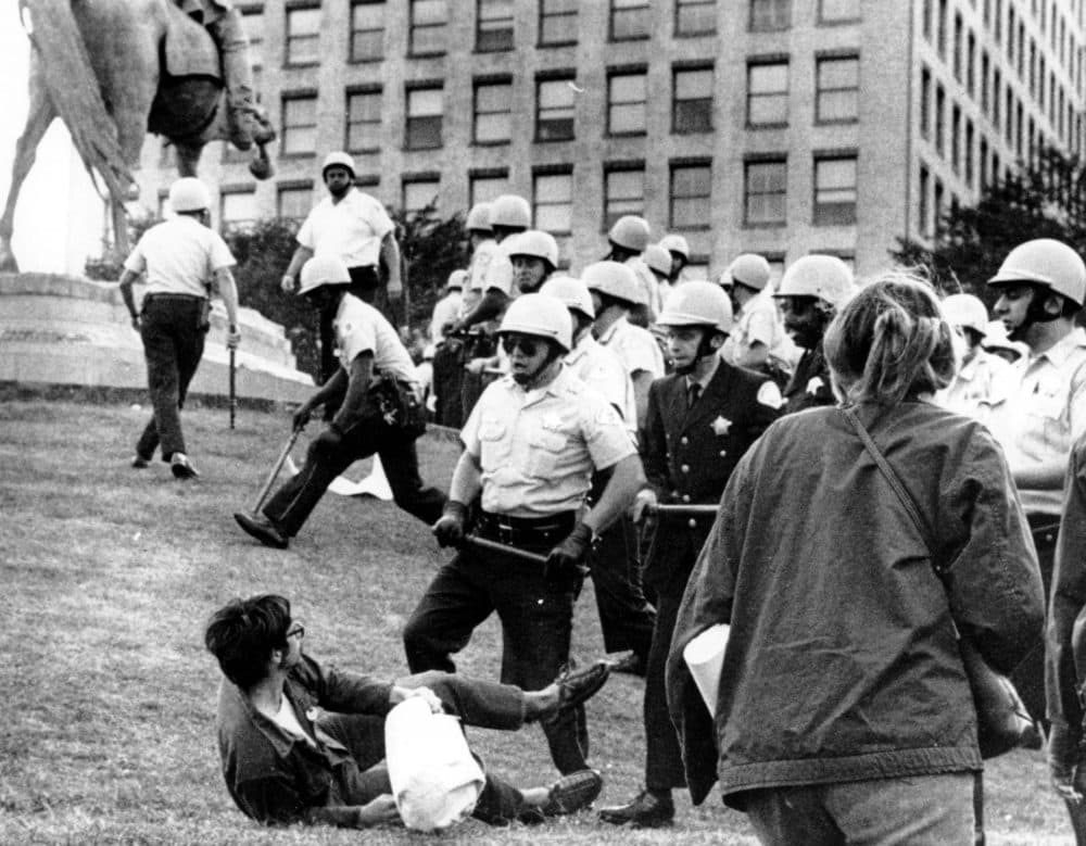 In this Aug. 26, 1968 file photo, Chicago police officers confront a demonstrator on the ground at Grant Park in Chicago during the city's hosting of the Democratic National Convention. (AP Photo)