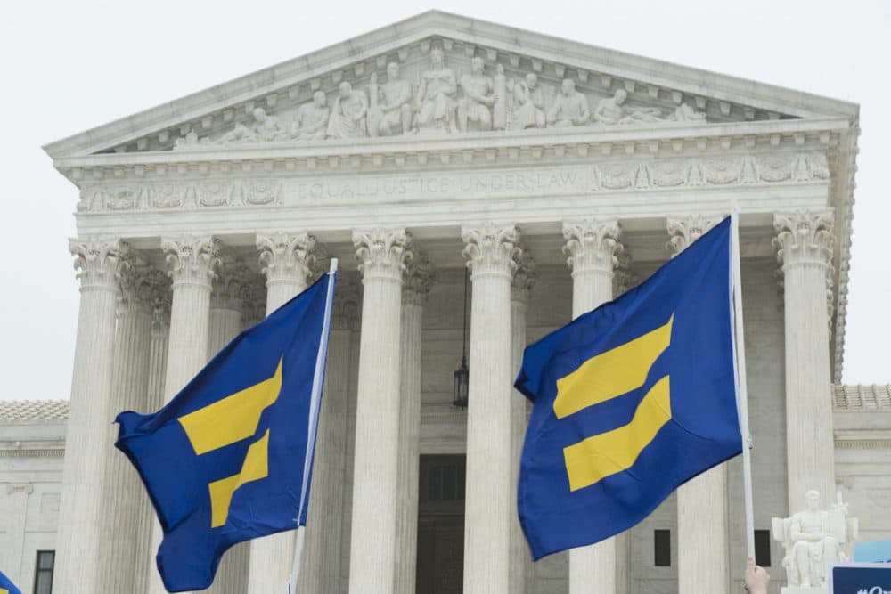 Supporters of LGBTQ equality fly Human Rights Campaign flags in front of the Supreme Court during oral arguments for Masterpiece Cakeshop case on Tuesday, Dec. 5, 2017, in Washington. (Kevin Wolf/AP Images for Human Rights Campaign)
