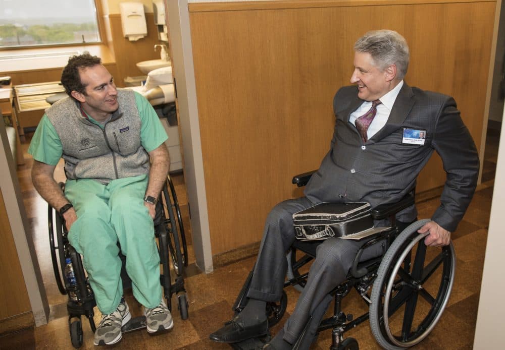 Dr. Daniel Grossman, left, a Mayo Clinic emergency room physician, credits neurologist Dr. Robert Brown with guiding him in recovery after being paralyzed as a result of a mountain bike accident last year. Brown, with a contagious positive attitude, helped Grossman return to work less than a year after his accident. (Jerry Olson for Here &amp; Now)