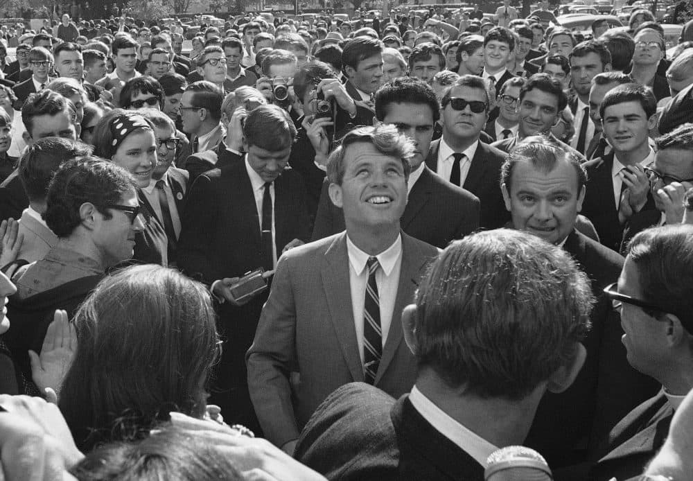 In this June 7, 1966 photo, Sen. Robert F. Kennedy is surrounded by students and newsmen as he tours Stellenbosch, South Africa during five-day visit to South Africa as the guest of the multiracial National Union of South African students. (Dennis Lee Royle/AP file photo)