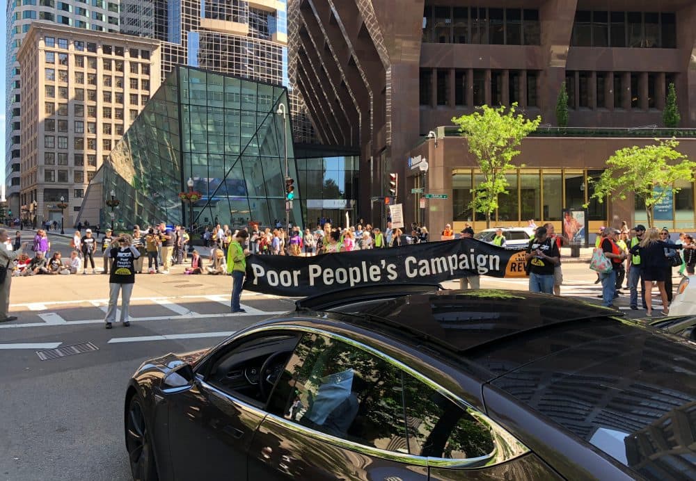 Activists with the Poor People's Campaign shut down the intersection of Congress and Franklin Streets Monday afternoon in downtown Boston. (Andy Metzger/State House News Service)