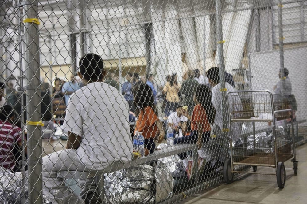 In this photo provided by U.S. Customs and Border Protection, people who've been taken into custody related to cases of illegal entry into the United States, sit in one of the cages at a facility in McAllen, Texas, Sunday, June 17, 2018. (U.S. Customs and Border Protection's Rio Grande Valley Sector via AP)