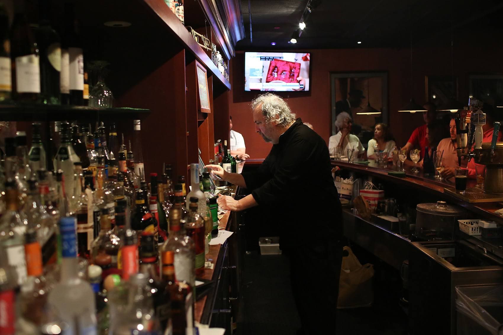 Rick Bogart works the bar at Ryles Jazz Club in Cambridge. (Hadley Green for WBUR)