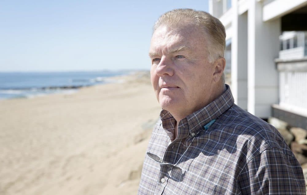 Plum Island resident Bob Connors in front of his house (Robin Lubbock/WBUR)