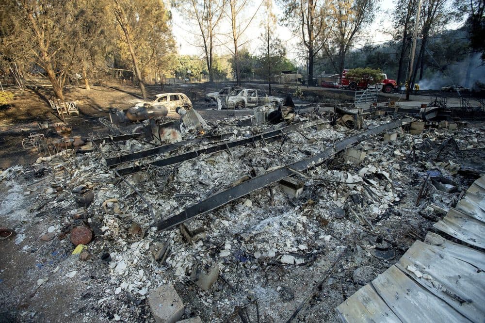 A structure leveled by a wildfire rests in a clearing on Wolf Creek Road near Clearlake Oaks, Calif., on Sunday, June 24, 2018. Wind-driven wildfires destroyed buildings and threatened hundreds of others Sunday as they raced across dry brush in rural Northern California. (Noah Berger/AP)